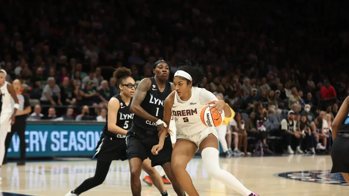 Angel Reese of the Atlanta Dream in a white number 5 jersey looks up
