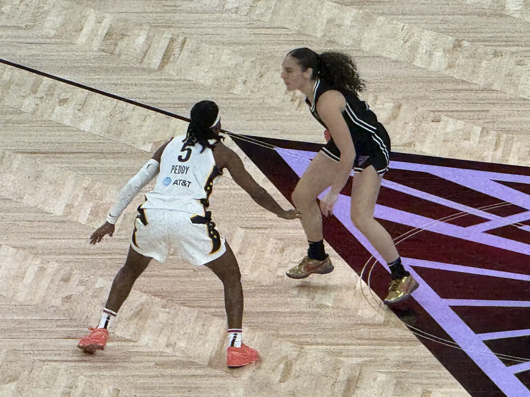 Carla Leite of the Golden State Valkyries in a purple jersey drives past a defender