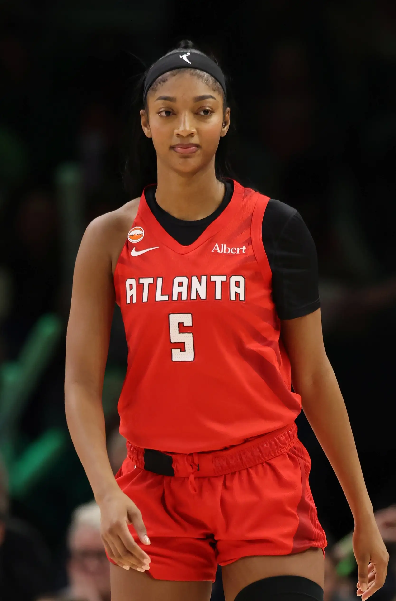 Angel Reese of the Atlanta Dream in a white jersey, number 5, looking up with her mouth open at Target Center