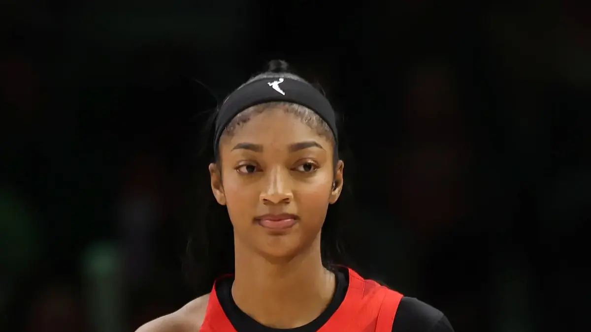 Angel Reese of the Atlanta Dream in a white jersey, number 5, looking up with her mouth open at Target Center