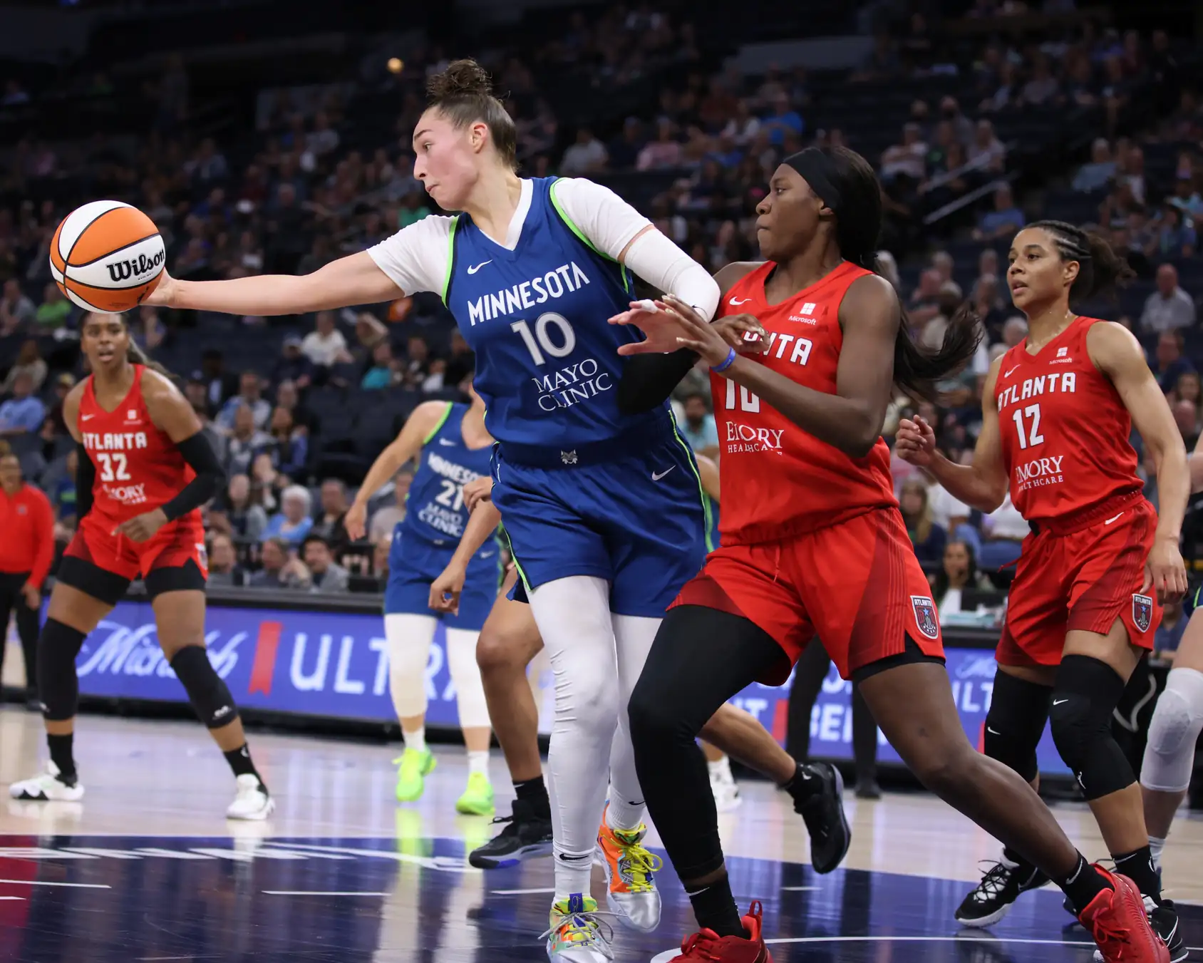 Rhyne Howard of the Atlanta Dream, in a white number 10 jersey, shoots a jumper against the Minnesota Lynx at Target Center