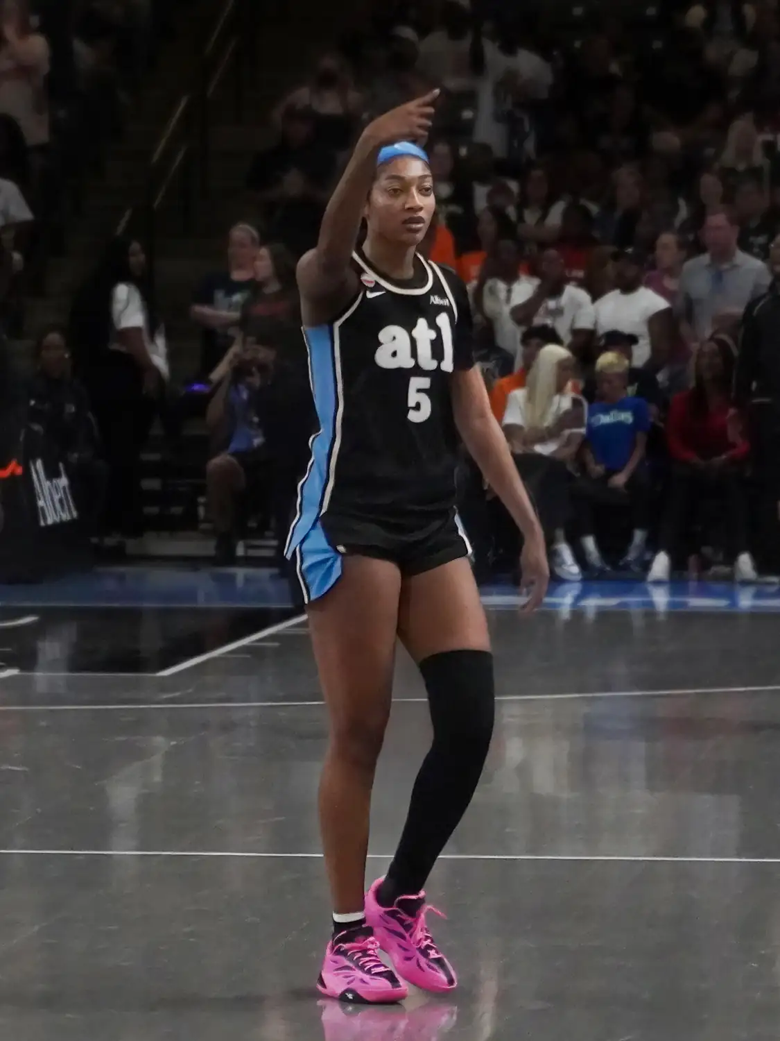 Angel Reese of the Atlanta Dream in a white jersey, number 5, looking to her right at Gateway Center Arena
