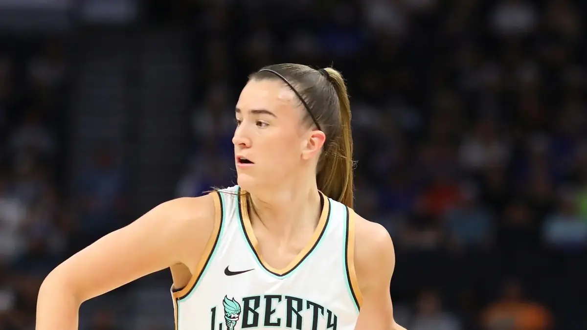 Sabrina Ionescu of the New York Liberty in a white number 20 jersey brings the ball up against the Minnesota Lynx