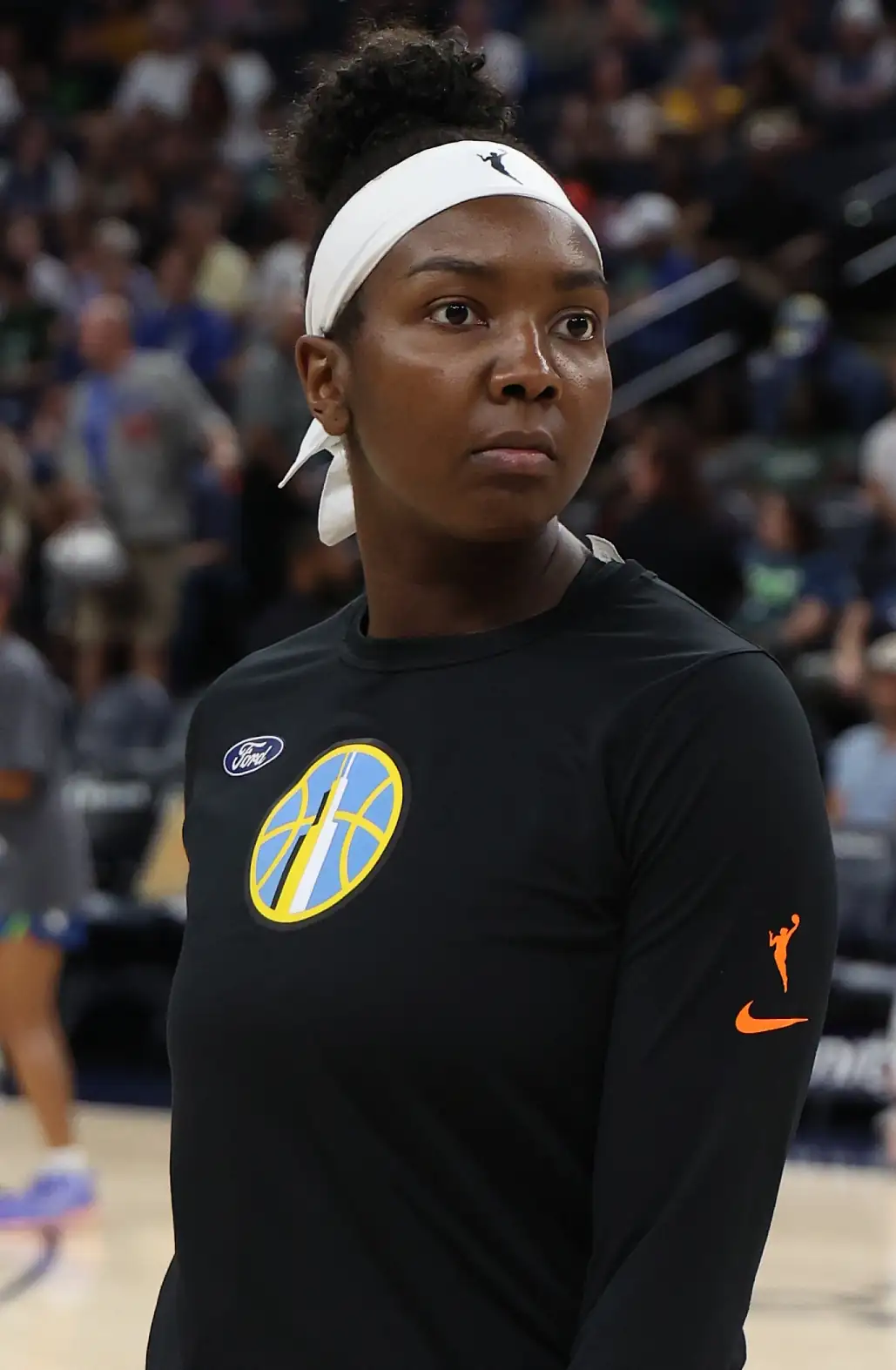 Elizabeth Williams of the Chicago Sky in a black warm-up shirt with the number 1, standing with a hand on her hip