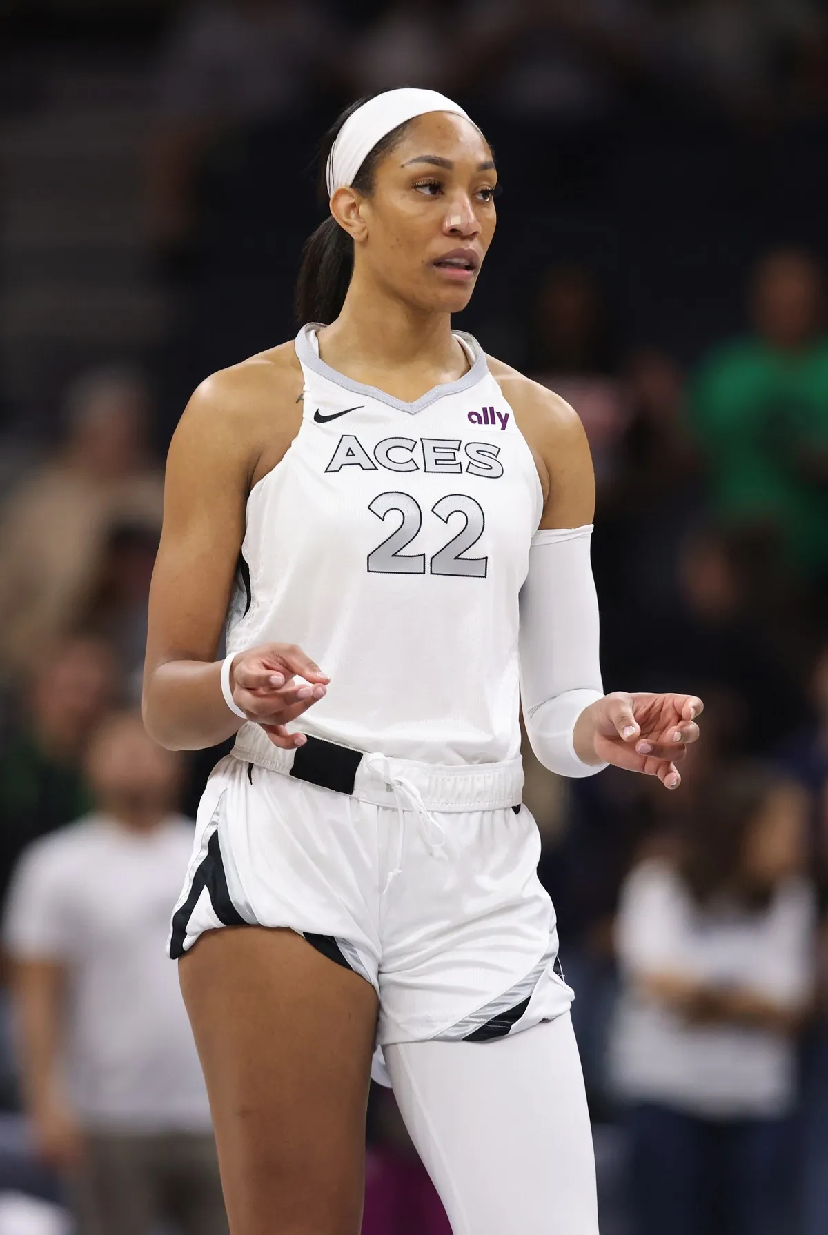 A'ja Wilson of the Las Vegas Aces, in a white number 22 Aces jersey, on the court at Target Center
