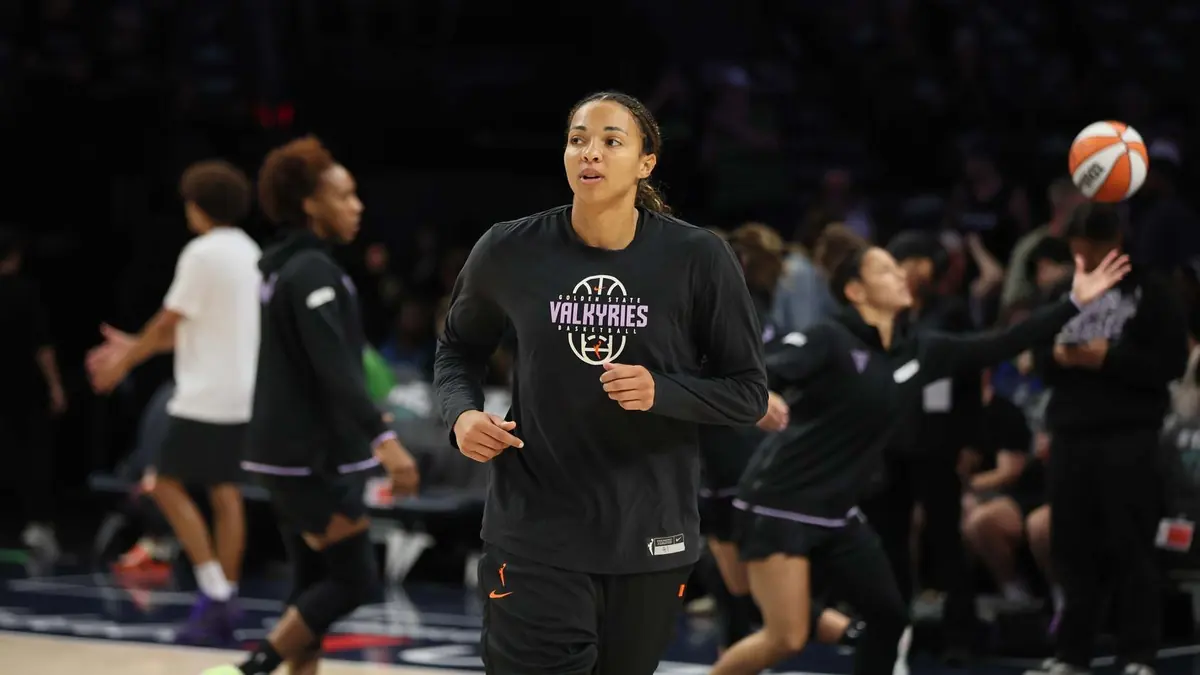 Kiah Stokes of the Golden State Valkyries jogging in a black Valkyries warmup shirt before a game