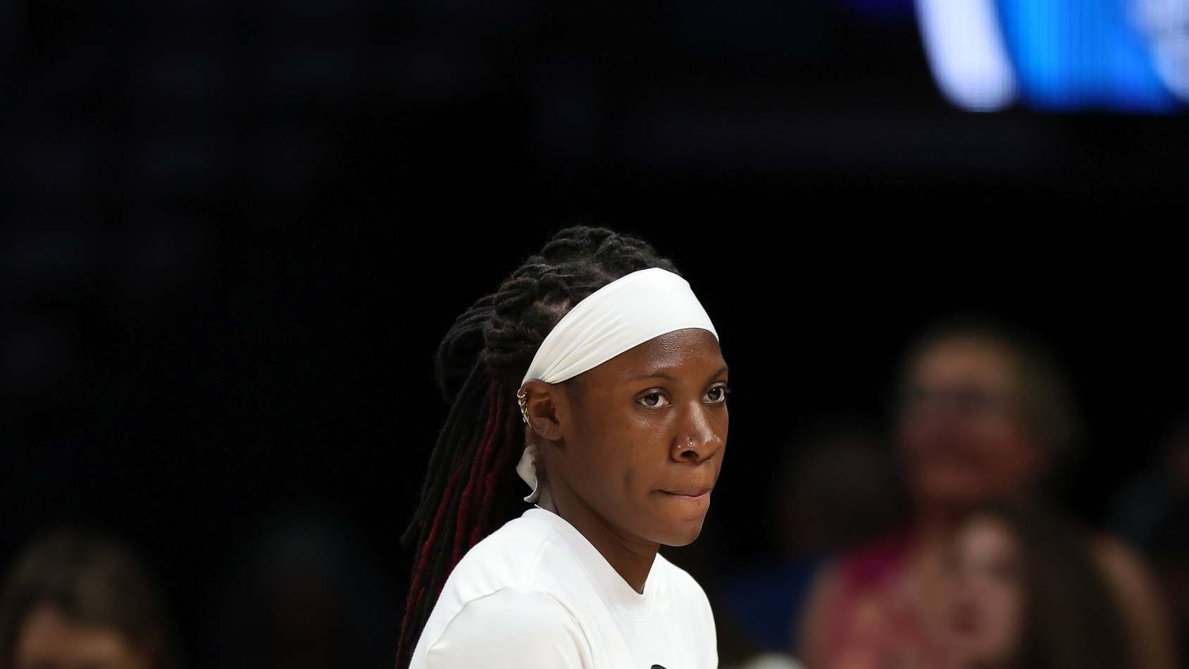 Rhyne Howard of the Atlanta Dream in a white warmup and white headband