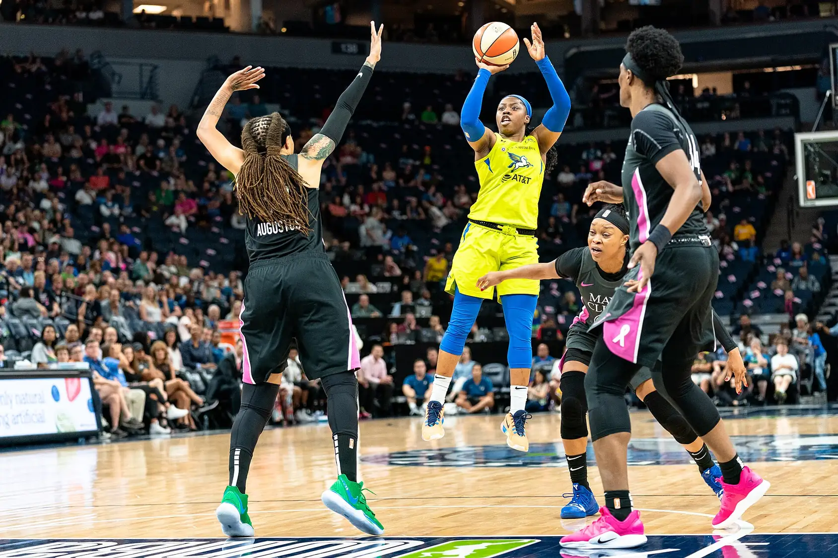 Arike Ogunbowale of the Dallas Wings shooting a jumper over a Minnesota Lynx defender
