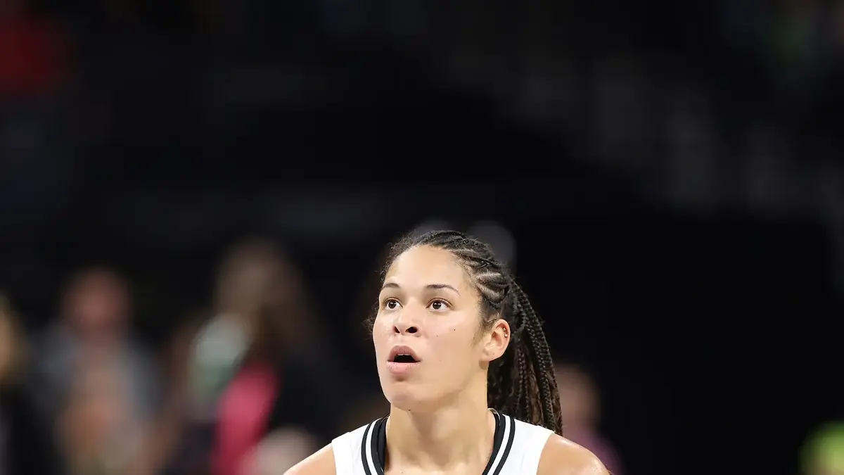 Veronica Burton of the Golden State Valkyries dribbling a basketball in a white jersey against the Minnesota Lynx