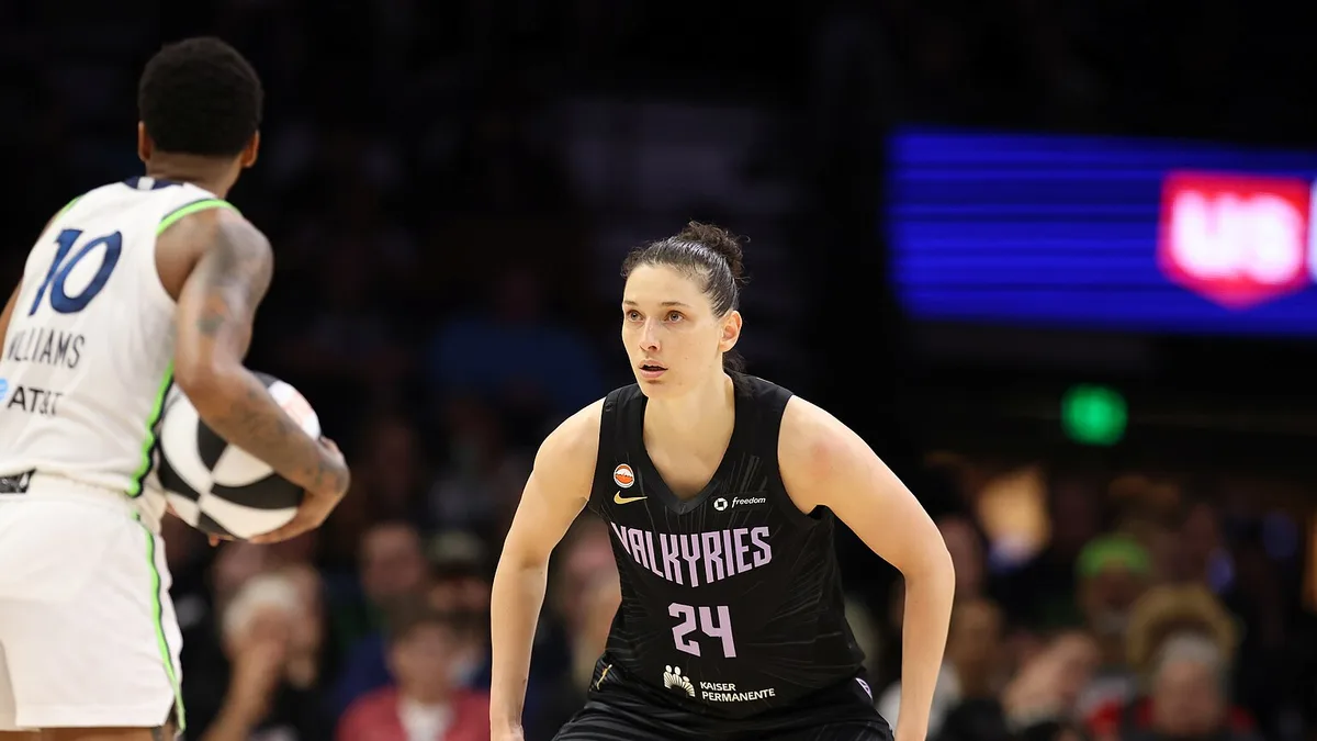 Cecilia Zandalasini of the Golden State Valkyries, number 24, defends a Minnesota Lynx player