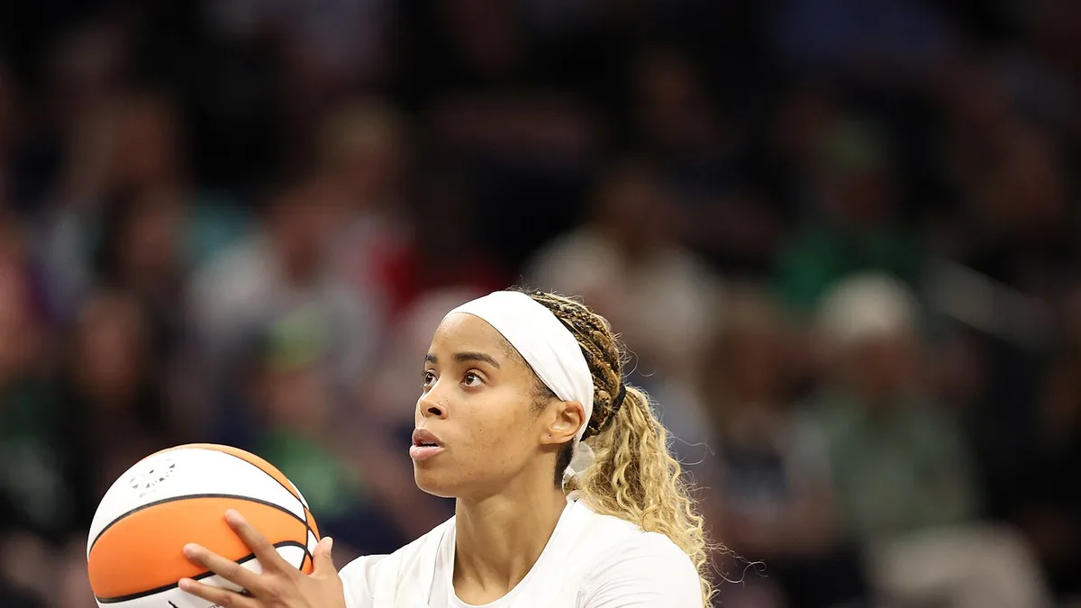Jordin Canada of the Atlanta Dream in a white number 3 jersey holding the ball