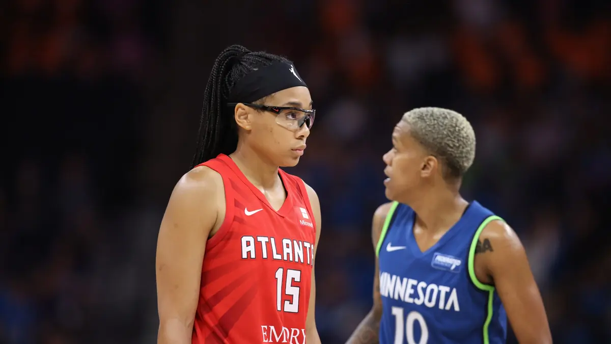 Allisha Gray of the Atlanta Dream in a red number 15 jersey, with a Minnesota Lynx player behind her